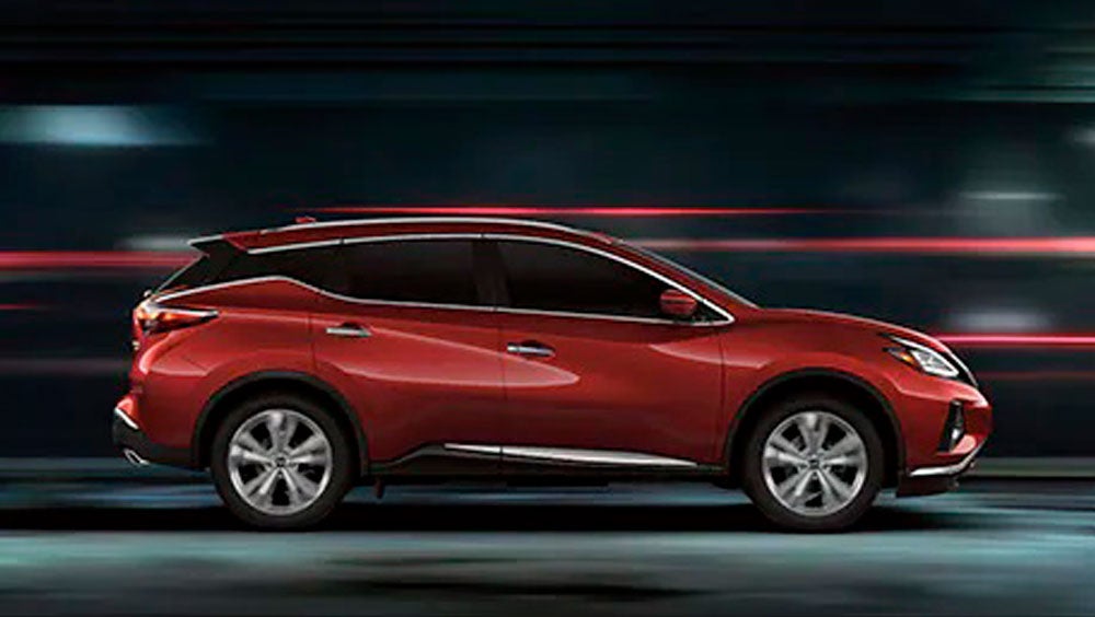 2023 Nissan Murano shown in profile driving down a street at night illustrating performance. | Benton Nissan Bessemer in Bessemer AL